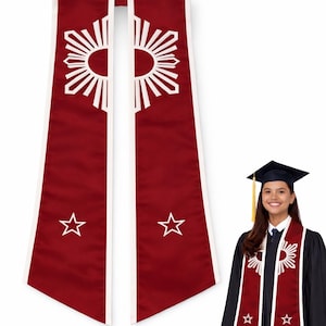 May include: Maroon graduation stole with white trim, featuring a sunburst design and stars. The stole is worn by a person in a graduation gown, symbolizing achievement and academic success.