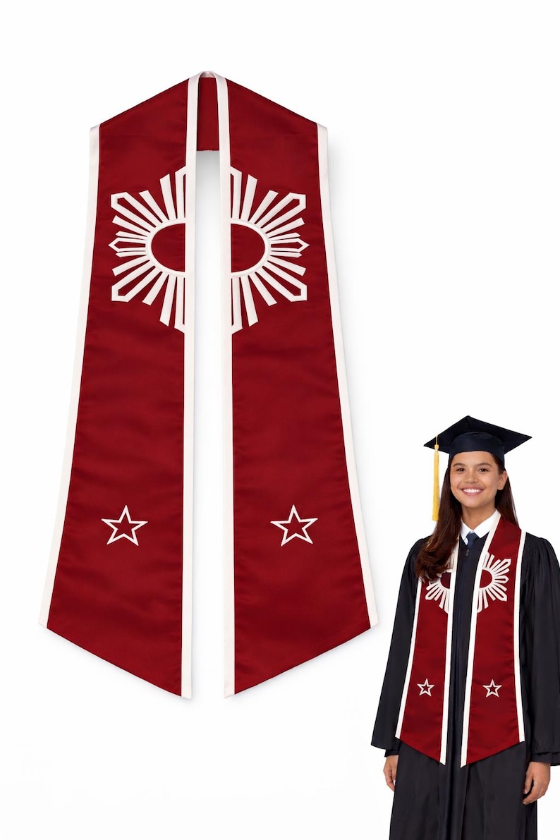 May include: Maroon graduation stole with white trim, featuring a sunburst design and stars. The stole is worn by a person in a graduation gown, symbolizing achievement and academic success.