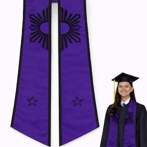 May include: Purple graduation stole with black trim, featuring a sunburst design and stars. The stole is worn by a person in a graduation gown and cap. The stole is a symbol of academic achievement.