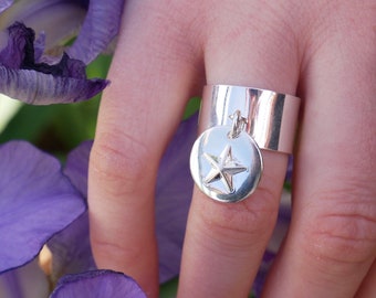 Silver plated charm ring with star pellet charm