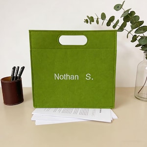 May include: A set of three ceramic nesting bowls in shades of blue, green, and white. The bowls have a speckled glaze and a simple, modern design. The largest bowl is about 15 cm in diameter.