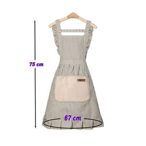 May include: A striped apron with a beige pocket and ruffled edges, hanging on a wooden hanger. The apron is approximately 29.5 inches long and 26.4 inches wide. The apron is designed for kitchen use.