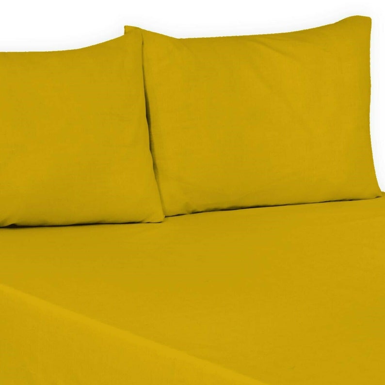 May include: A set of two yellow pillowcases. The pillowcases are made of a soft, smooth fabric.