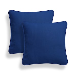 May include: Two blue square throw pillows with a soft, textured fabric.