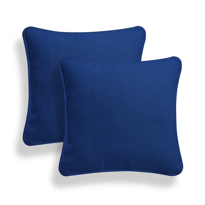 May include: Two blue square throw pillows with a soft, textured fabric.