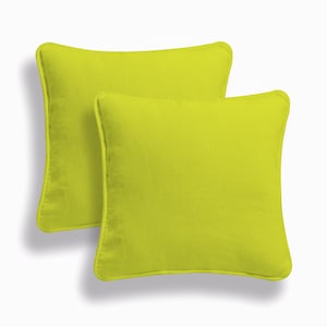 May include: Two lime green square throw pillows with a subtle texture. The pillows have a simple, modern design.
