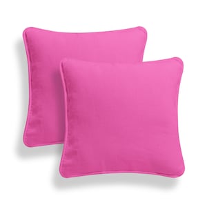 May include: Two pink square throw pillows with a simple design. The pillows are made of a soft, comfortable fabric.