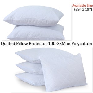 May include: A set of three white quilted pillow protectors, each with a zipper closure. The protectors are made of 100 GSM polycotton and are available in a size of 29 inches by 19 inches. "Quilted Pillow Protector 100 GSM in Polycotton" is written in black text at the bottom of the image.