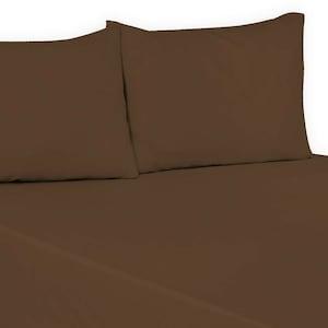May include: Two brown pillowcases, one on top of the other, with a brown fitted sheet underneath.