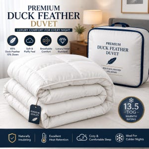 May include: A white, quilted duck feather duvet with a 13.5 tog warmth rating. The duvet is folded and includes a tag labelled Premium Quality. Beside it sits a white storage bag with the text Premium Duck Feather Duvet, 85% Duck Feather 15% Down.
