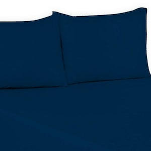 May include: Two dark blue pillowcases and a matching dark blue fitted sheet. The sheet is smooth and wrinkle-free.