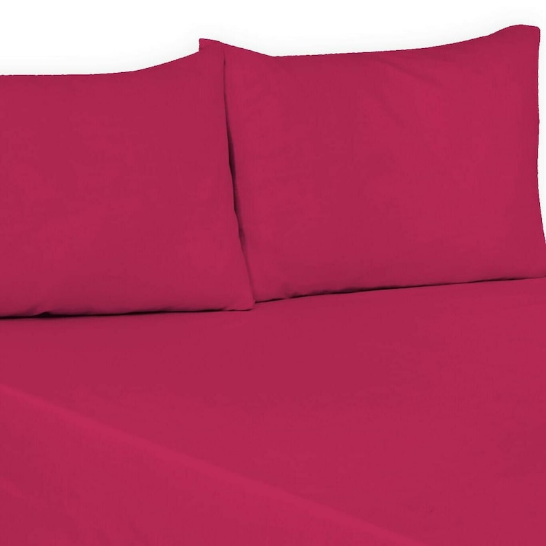 May include: A set of two pink pillowcases. The pillowcases are made of a soft, smooth fabric.