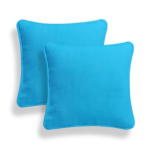 May include: Two turquoise blue square throw pillows with a subtle texture. The pillows are made of a soft, durable fabric and are perfect for adding a pop of color to any room.