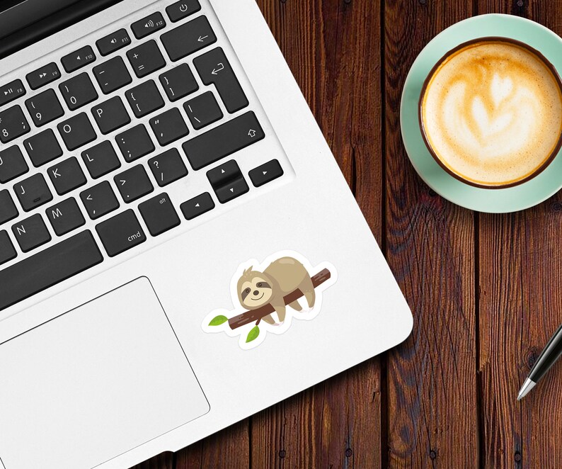 May include: A brown sloth with a white belly is sleeping on a branch with green leaves. The sloth is on a white laptop computer.