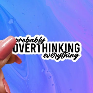 May include: White sticker with black text that reads "probably overthinking everything" on a blue and purple background.