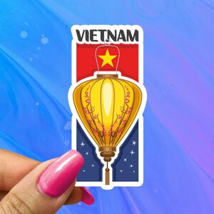 May include: A sticker featuring a yellow lantern with red flowers and a red star on a blue background. The text "VIETNAM" is at the top of the sticker.