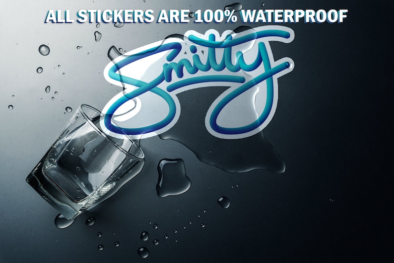 May include: A blue and white sticker with the word "Smitty" written in a cursive font. The sticker is on a dark gray surface with water droplets around it. The text "ALL STICKERS ARE 100% WATERPROOF" is at the top of the image.
