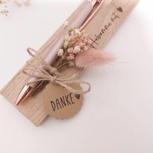May include: A rustic wooden sign with the text "Welcome to our home" in white lettering. The sign features a distressed finish and a simple, inviting design, perfect for a front porch or entryway.