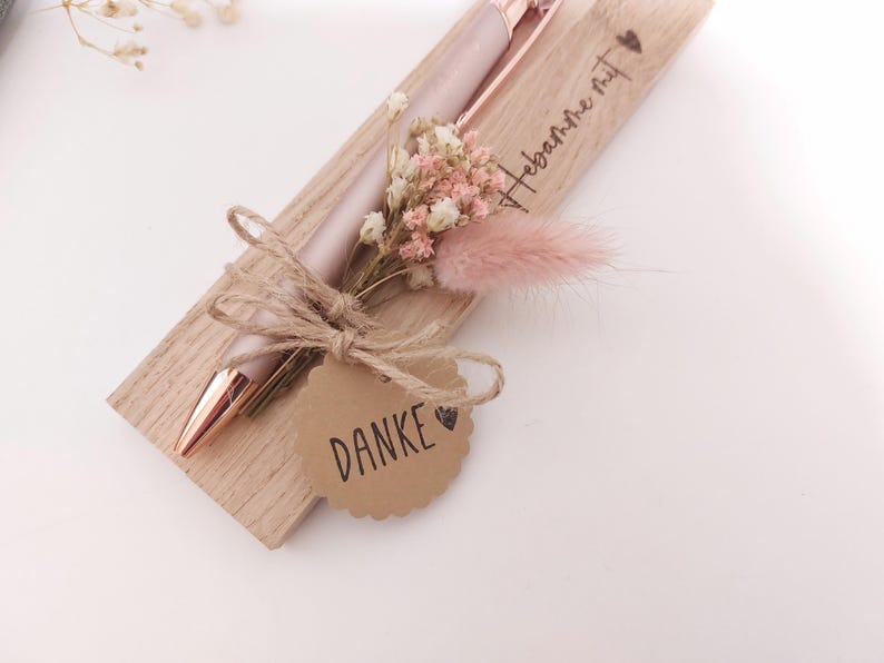 May include: A rustic wooden sign with the text "Welcome to our home" in white lettering. The sign features a distressed finish and a simple, inviting design, perfect for a front porch or entryway.