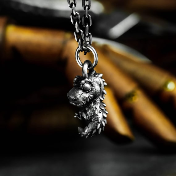 A teeny 925 silver T-Rex pendant that looks like it escaped from a toy chest — handcrafted with that chunky cartoon charm that's impossible not to smile at.