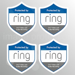 May include: Four security stickers with a shield design. Each sticker has a blue border and the text "Protected by ring". Below the ring logo is the text "24/7 Video and Audio Recording". The background is a gradient of white to grey.
