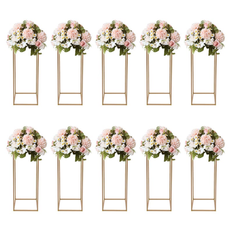 May include: Ten floral arrangements featuring pink and white flowers atop gold metal stands. The flowers are arranged in a full, rounded shape. The stands have a square base and a rectangular frame.