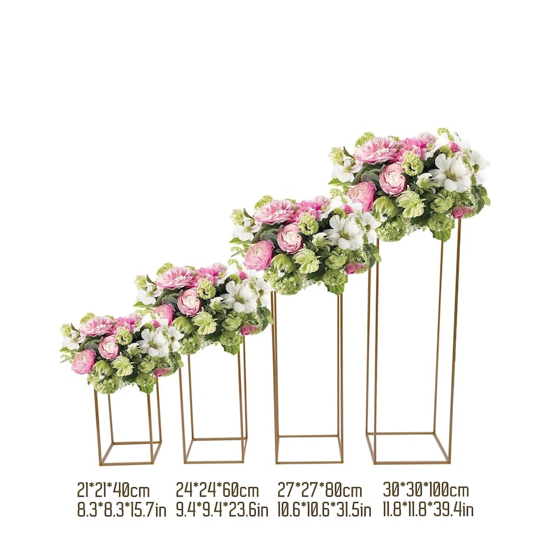 May include: Four gold metal floral stands of varying heights, each topped with a bouquet of pink, white, and green flowers. The stands are square-shaped, with dimensions ranging from 8.3x8.3x15.7 inches to 11.8x11.8x39.4 inches. The flowers are in full bloom.