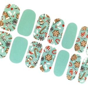May include: Set of ten teal blue nail wraps with a Christmas theme. The design features gingerbread cookies, candy canes, holly, and stockings.