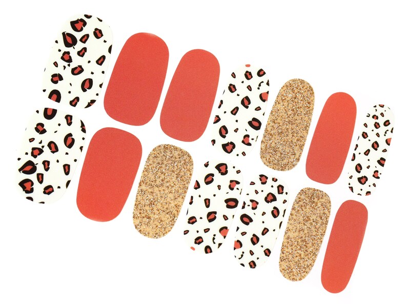 May include: Nail art stickers in a variety of designs. The stickers include solid orange, gold glitter, and white with red and black leopard print patterns. These nail art stickers are perfect for creating a unique manicure.