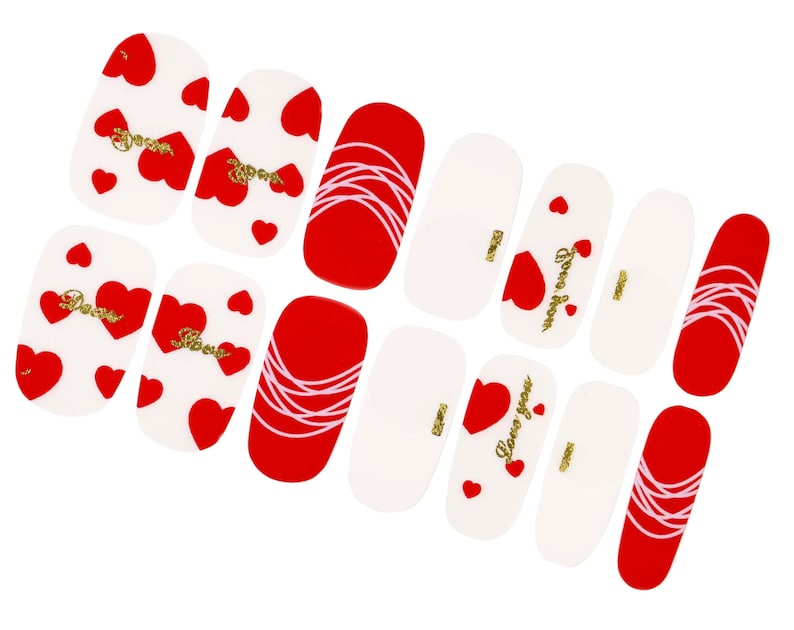 May include: Set of 10 red and white nail stickers with heart and swirl designs. Some stickers feature the text "Love you".