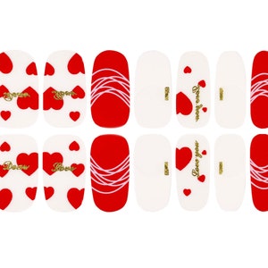 May include: Set of 12 red and white nail stickers with heart and swirl designs. Some stickers feature the text "Love you" and "Love always".