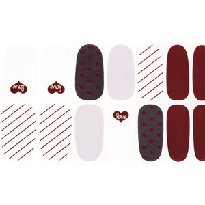May include: Nail polish wraps with a variety of designs, including red and white stripes, polka dots, and solid red. The wraps also feature the words "love" and "you" in a heart shape.