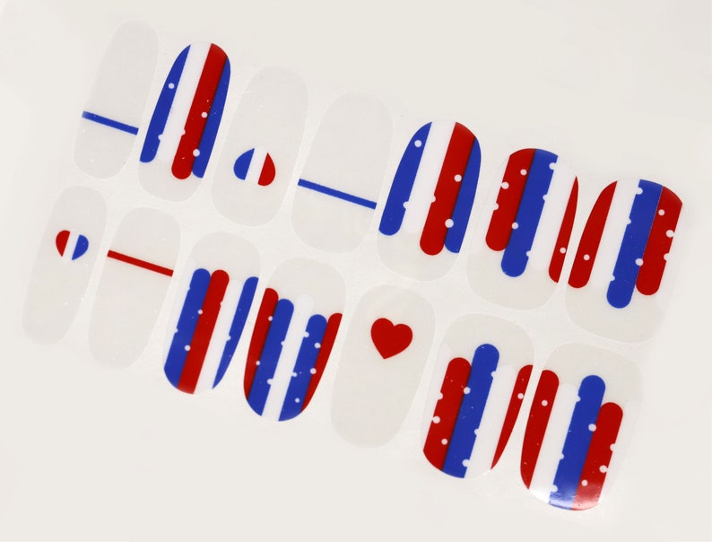 May include: Nail art stickers with red, white, and blue stripes and polka dots. Some stickers feature a heart shape.