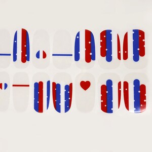 May include: Set of 12 nail decals featuring red, white, and blue stripes, hearts, and dots. The decals are designed for nail art and can be used to create a patriotic look.