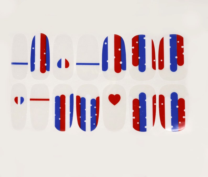 May include: Set of 12 nail decals featuring red, white, and blue stripes, hearts, and dots. The decals are designed for nail art and can be used to create a patriotic look.