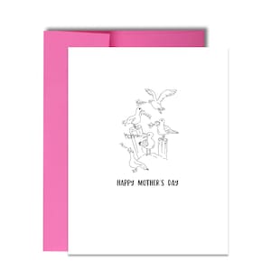 May include: A white greeting card with a pink envelope. The card features a black and white illustration of seagulls perched on wooden posts, with the words "HAPPY MOTHER'S DAY" below the illustration.