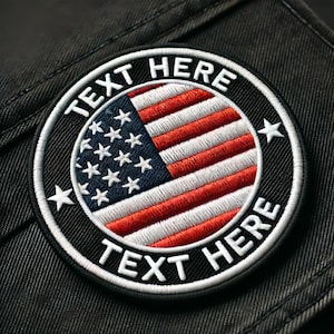 May include: A black and white embroidered patch with a red, white, and blue American flag in the center. The text "TEXT HERE" is written around the flag in white.
