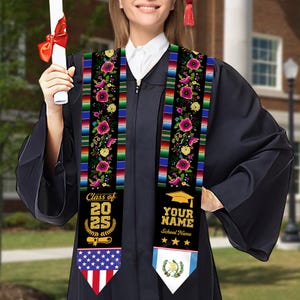 May include: A graduation stole with a black base, adorned with floral embroidery and colorful stripes. The stole features the text "Class of 2025" and space for a name and school. The bottom of the stole displays the American and Guatemalan flags.