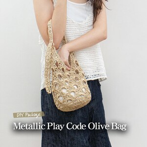 May include: A beige crochet bag with a woven design and fringe details. The bag is being held by a person wearing a white crochet top and blue jeans. The text "DIY Package Metallic Play Code Olive Bag" is displayed below the image.
