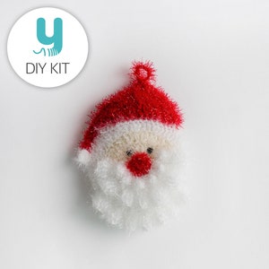 May include: A white and red crocheted Santa Claus ornament with a fluffy white beard and a red hat.