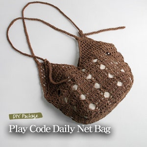 May include: A brown crocheted net bag with a drawstring closure. The bag has a  "DIY Package" label and the text "Play Code Daily Net Bag".