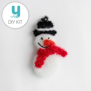 May include: A white snowman with a black hat and red scarf. The snowman has a red nose and a smiling face.