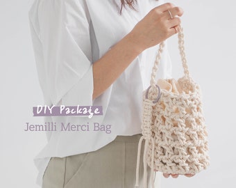 May include: DIY crochet bag kit, featuring a beige crochet bag with a purple ring and a white drawstring. The kit includes one ball of Jemilli yarn and a crochet bag pattern.