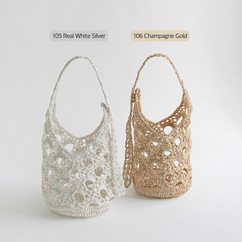 May include: Two crocheted bags, one in white silver and one in champagne gold. The bags have a round, open-weave design and are both hanging from their handles.