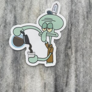 May include: A sticker featuring Squidward from Spongebob Squarepants pouring coffee into a cup. Squidward is depicted in his usual grumpy expression, wearing a brown shirt and a sailor hat. The sticker has a white border and is set against a gray background.