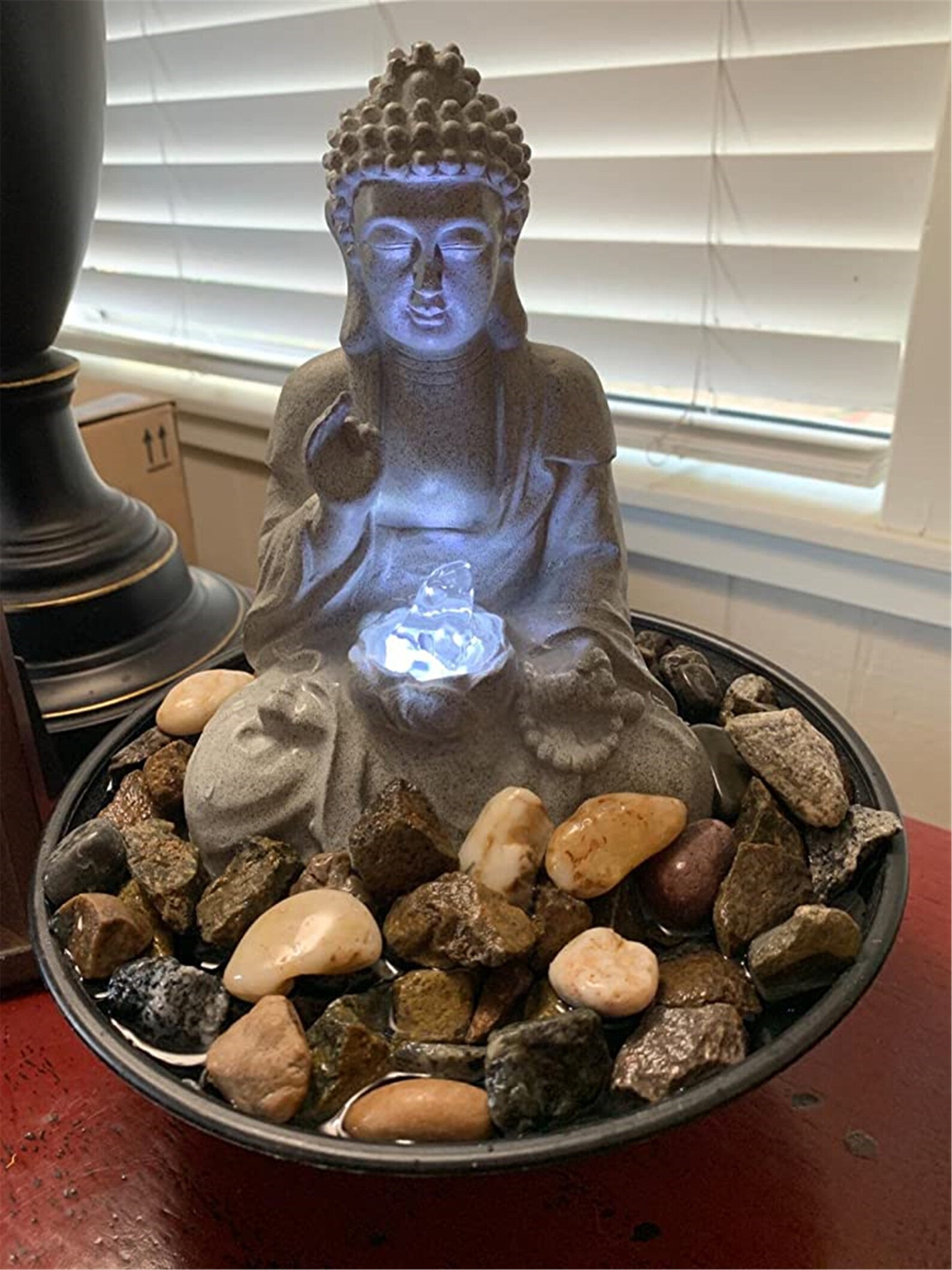 resin meditating buddha on column patio fountain with led light