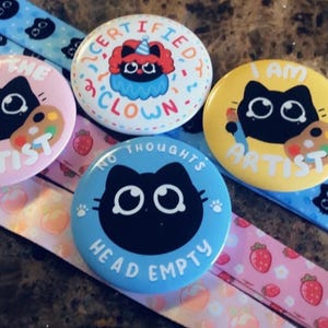 Anxious Cat badges and lanyards