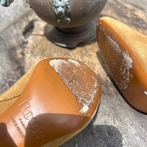 May include: A set of three ceramic mugs with a speckled, matte finish. The mugs are in shades of cream, light gray, and dark gray. Each mug has a simple, minimalist design and a rounded handle.