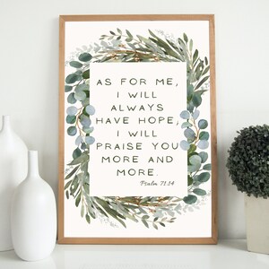 May include: A framed print with a watercolor illustration of eucalyptus leaves surrounding a quote from Psalm 71:14. The quote reads "As for me, I will always have hope, I will praise you more and more."
