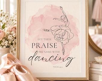 May include: A framed wall art print featuring a black line drawing of a ballerina whose skirt is a flower. The background has a soft pink watercolor wash. The text reads: LET THEM PRAISE HIS NAME WITH dancing PSALM 149:3. Pink satin ballet slippers sit in front.